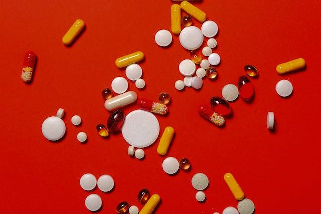 pills and drugs through on a red table