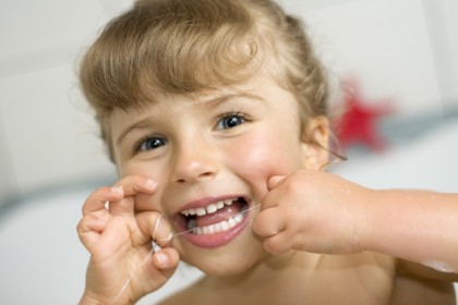girl cleaning her teeth