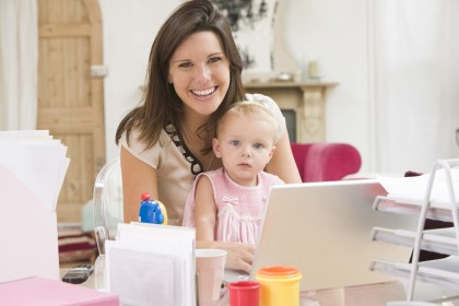 mumpreneur and baby at laptop