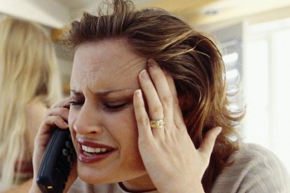 stressed woman holding her head with two hands