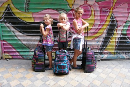 kids in paris with luggage posing for mums magazine
