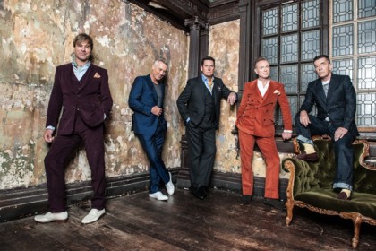 Spandau Ballet wearing elegant suits posing for mums magazine