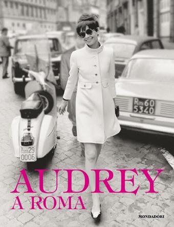audrey a roma wearing white coat posing near an Italian motorbike for mums magazine