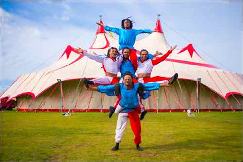 A sm The Kenya Boys - an exuberant human pyramid in front of the Big Top at Zippo's Circus. Photographer Piet-Hein Out
