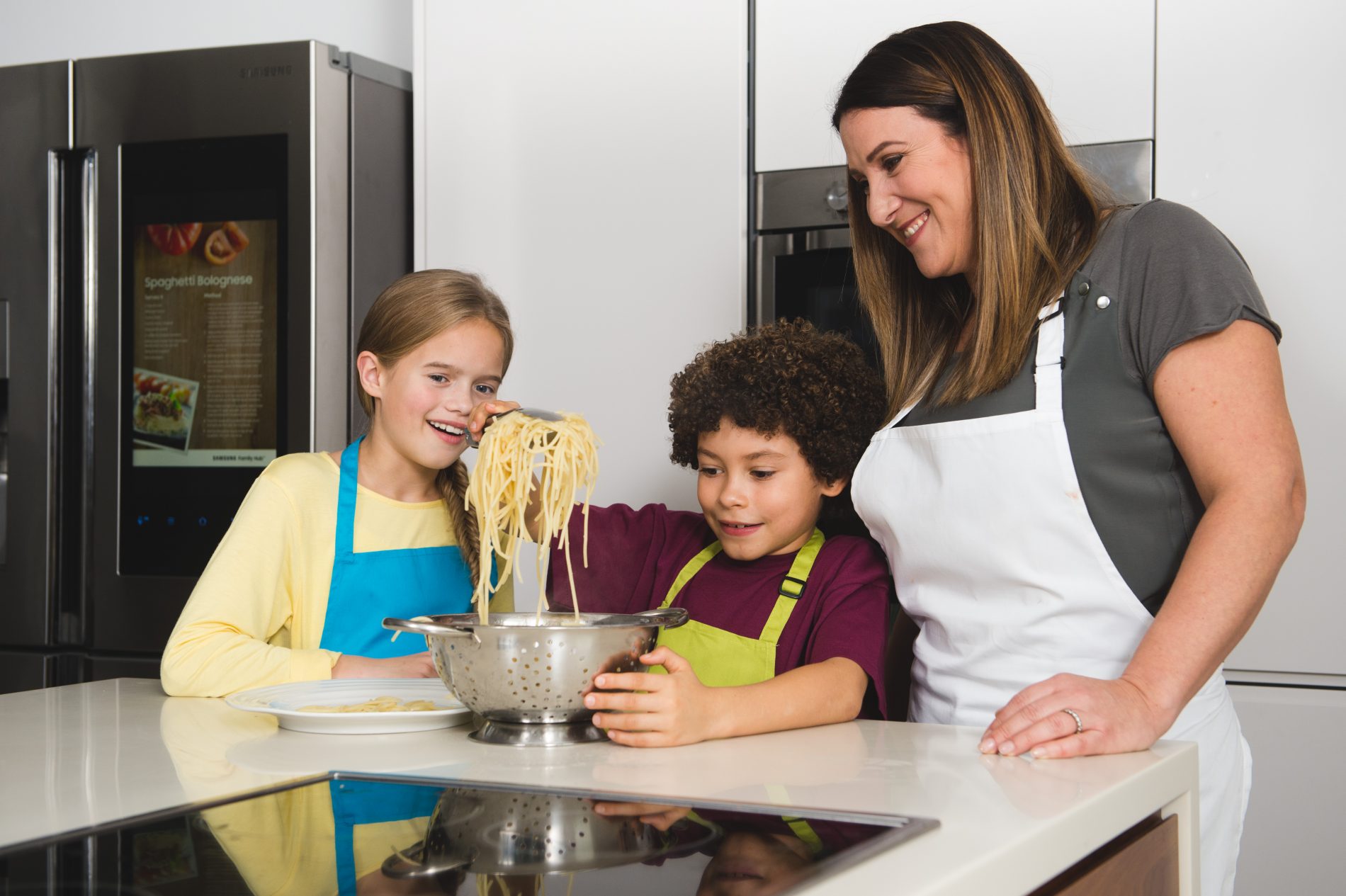 EMBARGOED TO 0001 THURSDAY NOVEMBER 24. EDITORIAL USE ONLY. MasterChef finalist Emma Spitzer teaches Harvey, aged 9, and Hattie, aged 10, to make some of the top 25 recipes children should be able to cook by the age of 11, following research compiled by Samsung in a new study to launch the Family Hub Refrigerator. Issue date: Thursday November 24, 2016. In a new UK wide initiative to reduce food wastage by encouraging families to cook together, Samsung has revealed that the average UK household wastes £51,000 of food over a lifetime, and one of the top five reasons for this is children leaving food on their plates. Pictures by: Daniel Lewis.