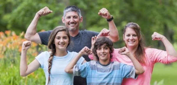 family dealing with loss of income but cheering up while posing for mums magazine