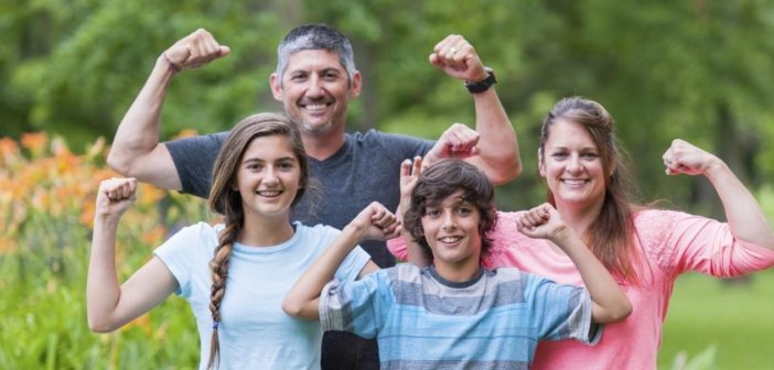 family dealing with loss of income but cheering up while posing for mums magazine