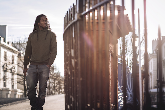 Nigel Clarke wearing grey jumper watching in the distance near gate 