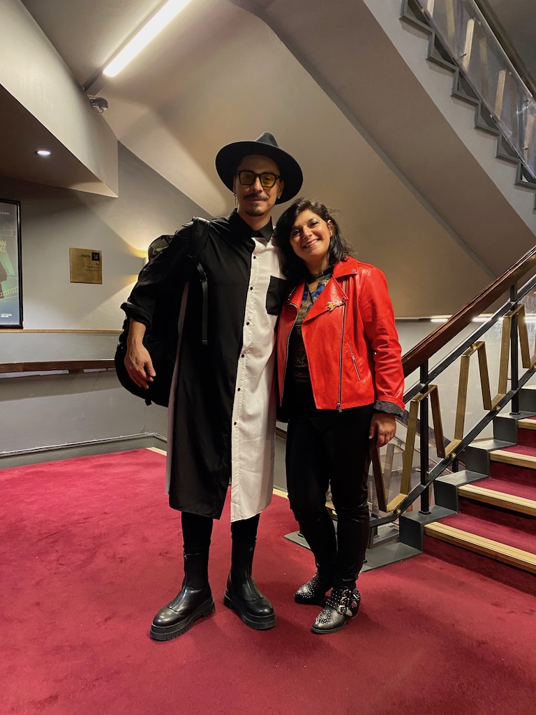 musician Luciano Bassi and Monica Costa wearing red jacket posing for mums magazine