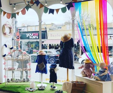 Colourful window display in Chiswick with kids clothes and bunting 