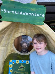 teenage boy posing with donkey puppet in London for mums magazine