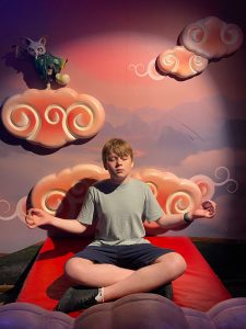 teenage boy practising yoga posing for mums magazine