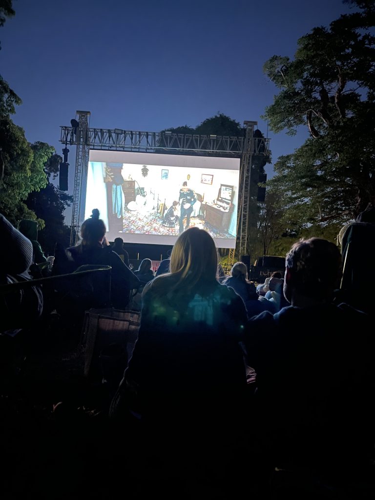 people watching luna cinema screening of elvis movie at kew gardens mums and kids having pic nic in the park