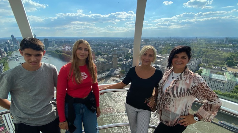 Mums and teenagers on a capsule on the London Eye panoramic wheel posing for mums magazine