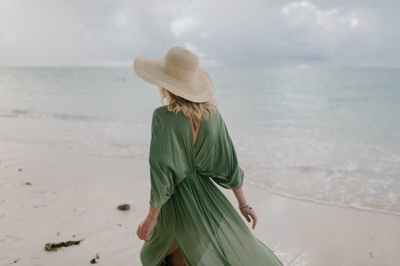 woman wearing green dress walking on a beach in the English Riviera posing for mums magazine