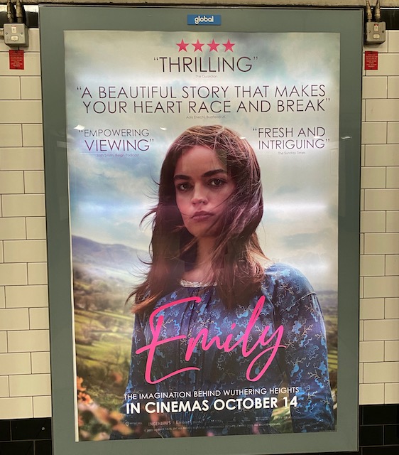 Movie poster on London Tube showing woman wearing Victorian dress posing for camera