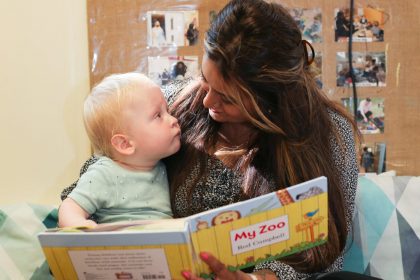 mum and baby looking at each other reading posing for mums magazine
