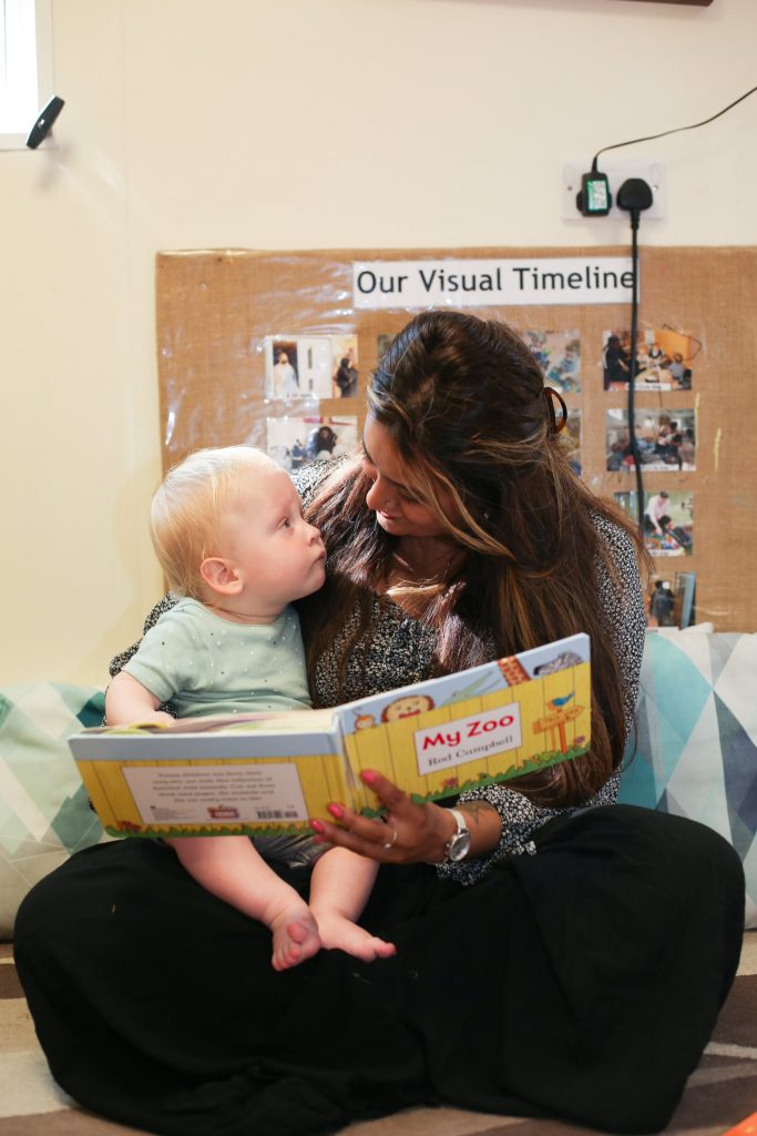 mum and baby looking at each other reading posing for mums magazine