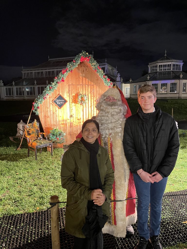 mummy blogger and teenage son posing with santa at his grotto for mums magazine at Kew Gardens 