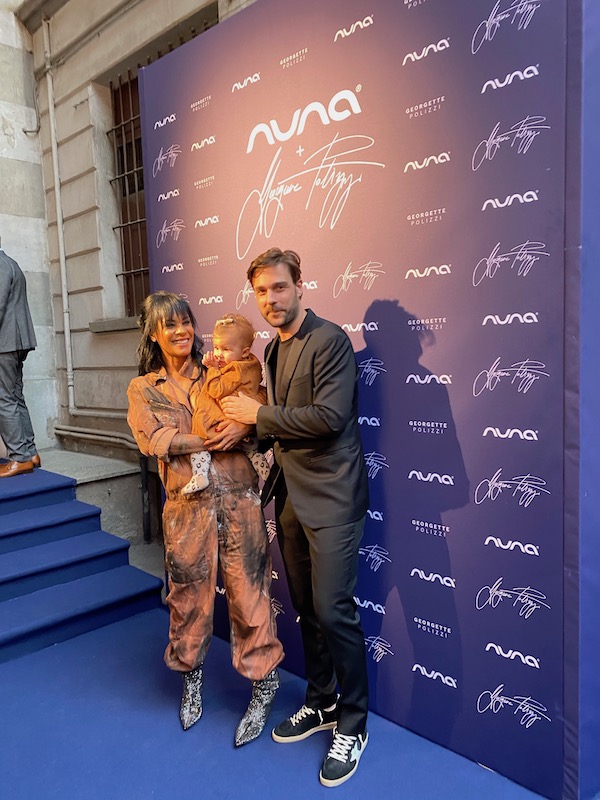 Georgette polizzi with husband and baby sole at nuna party in milan italy posing for mums magazine
