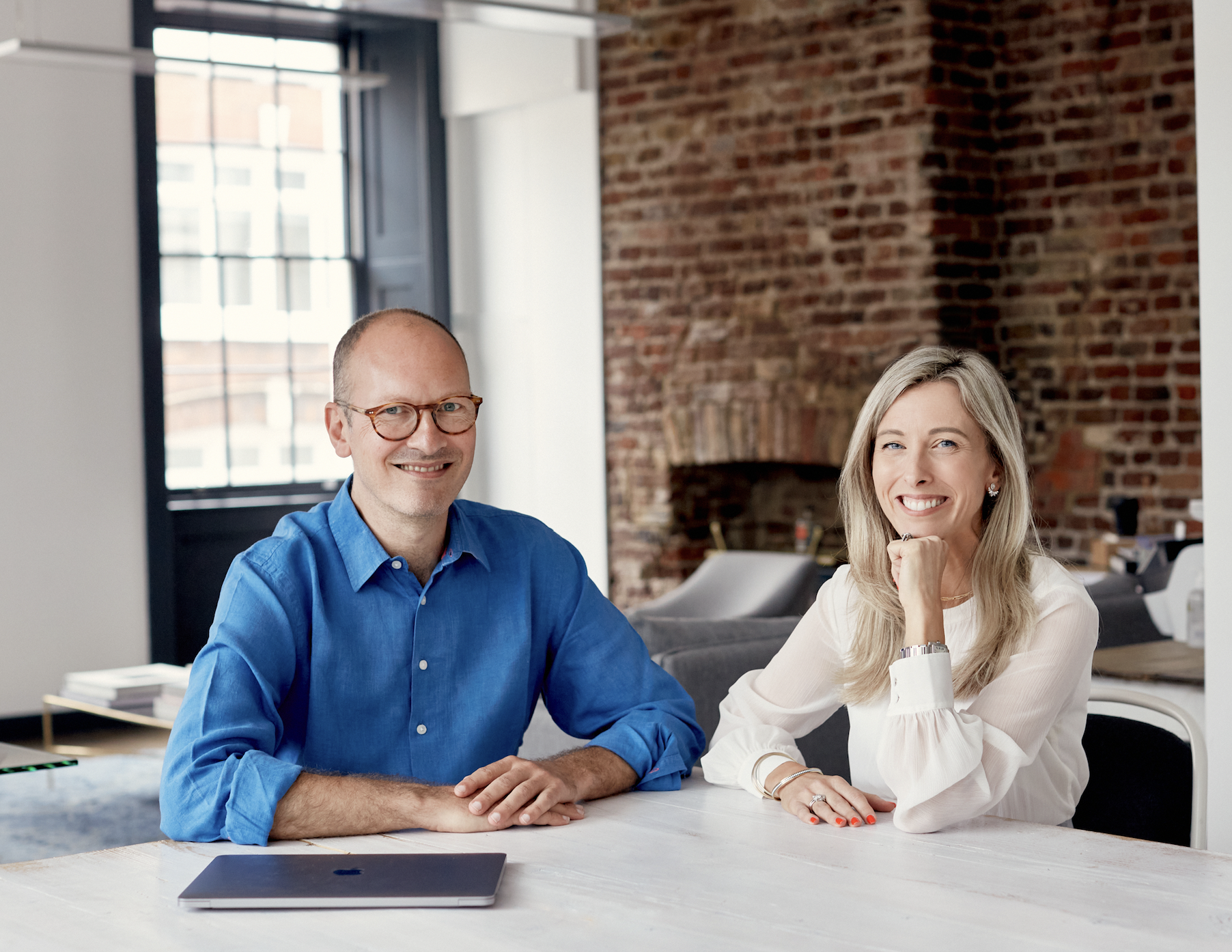 Harry and Samantha sitting at desk at The Divorce Surgery posing for mums magazine