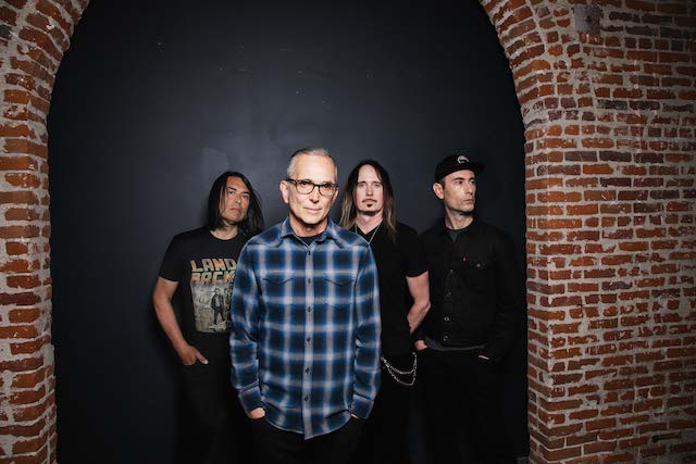 everclear band under a brick wall archway