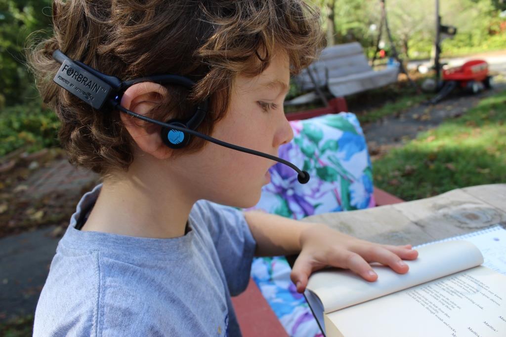 young boy using forbrain headphones