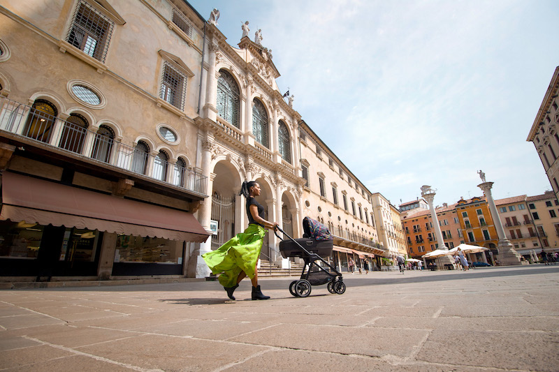 georgette polizzi holding a rainbow colour stroller posing for mums magazine