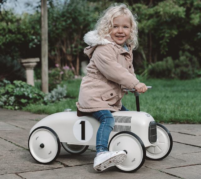 blonde girl riding a white Metal Ride-on Car by Hippychick 