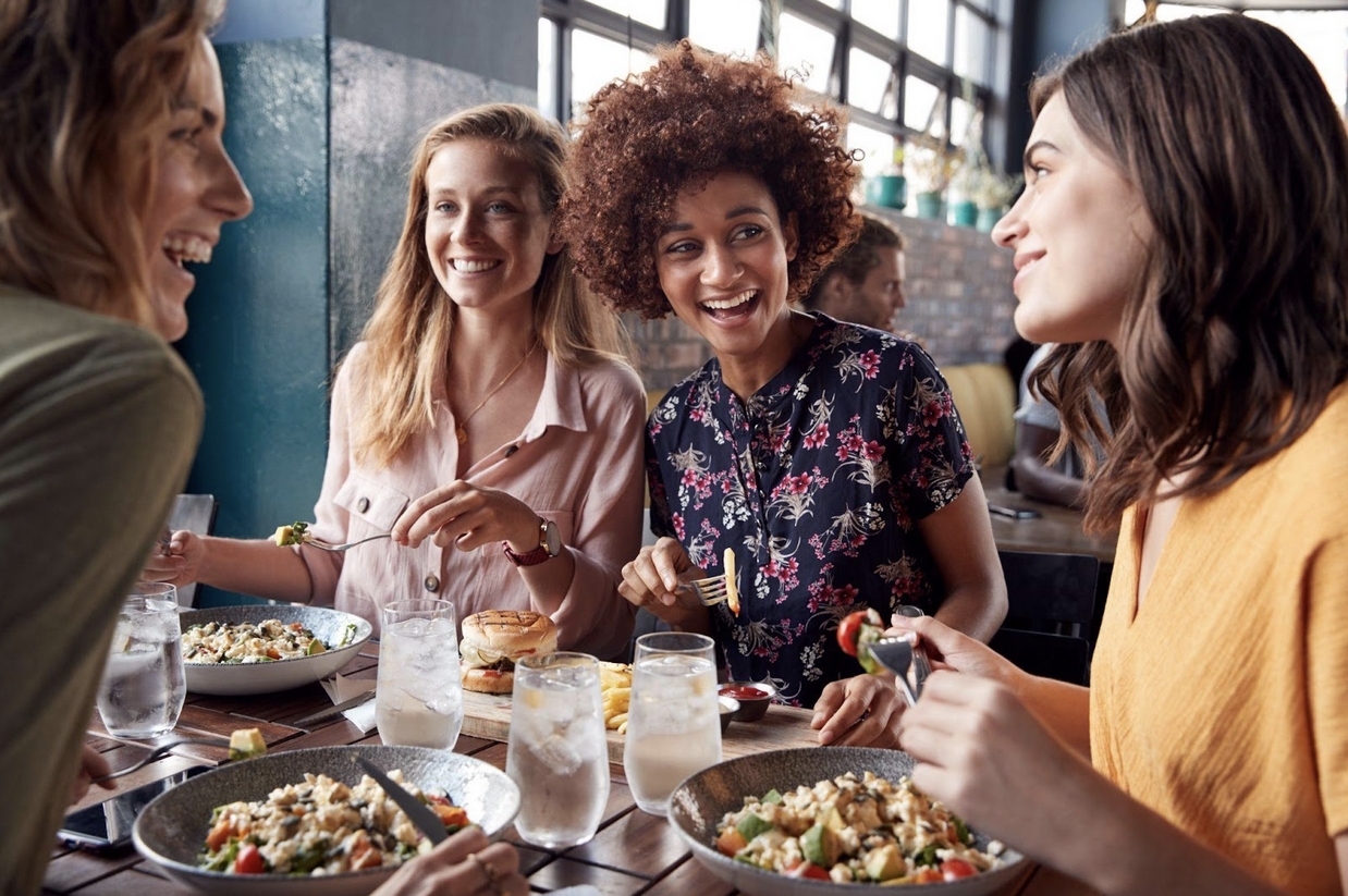 women laughing while on a mums day out trying cheese