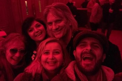 John Berry of Slade at Christmas gig posing with a group of fans