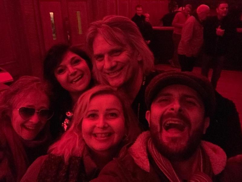 John Berry of Slade at Christmas gig posing with a group of fans