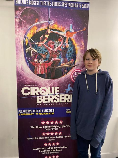 Alec next to Cirque Berserk show poster