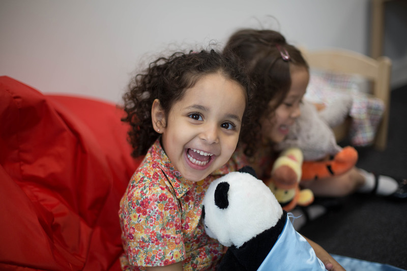 girl at school hugging a panda plush at Kensington wade 