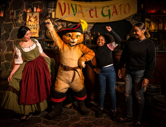 puss in boots with kids posing for mums magazine at SHREKS ADVENTURE london attraction