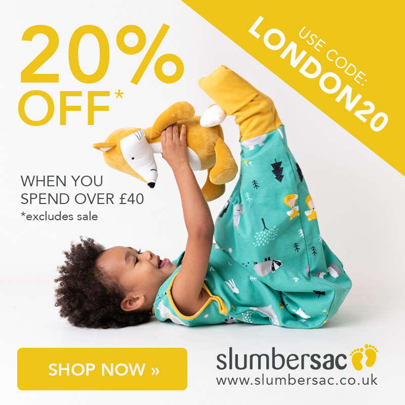 baby playing with fox plush