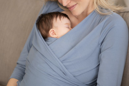 mum wearing a seraphine breastfeeding top while holding her sleeping baby