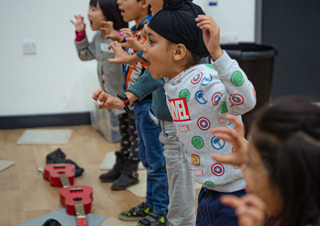 kids running and learning to play guitar