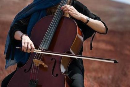 woman playing viola during travels