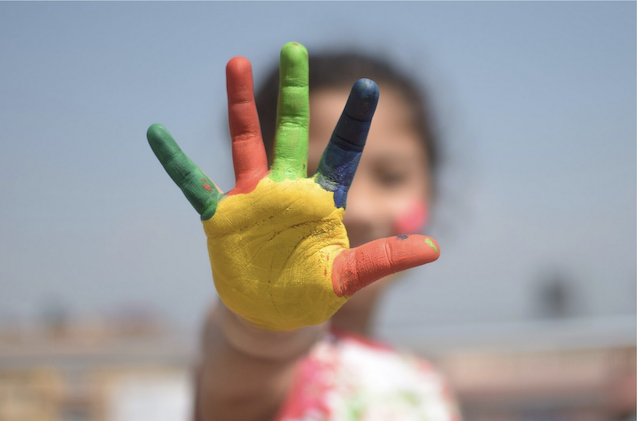 child with painted fingers 