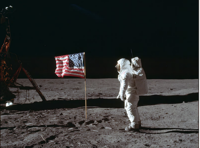 In this July 20, 1969, photo made available by NASA, astronaut Buzz Aldrin Jr. poses for a photograph beside the U.S. flag on the moon during the Apollo 11 mission. “Fly Me To The Moon,” an upcoming romantic comedy starring Scarlett Johansson and Channing Tatum, plays on popular moon landing hoax theories. | Neil Armstrong, NASA via Associated Press