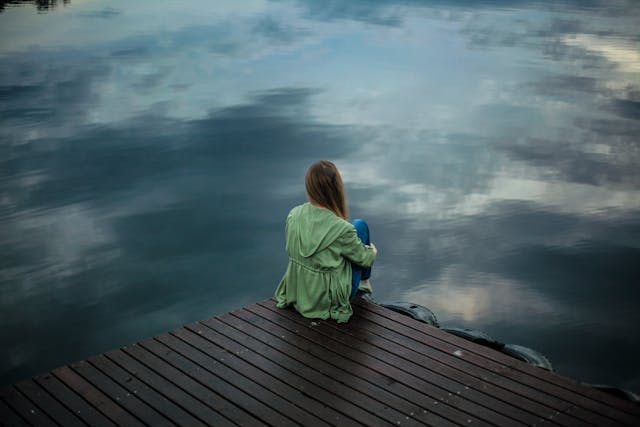 woman looking at a cloudy sky
