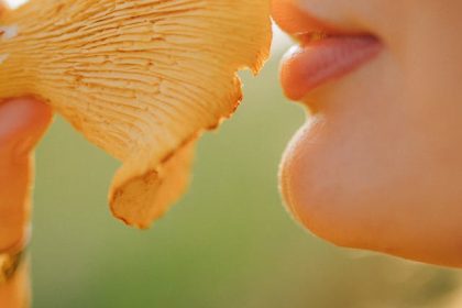 woman holding a mushroom