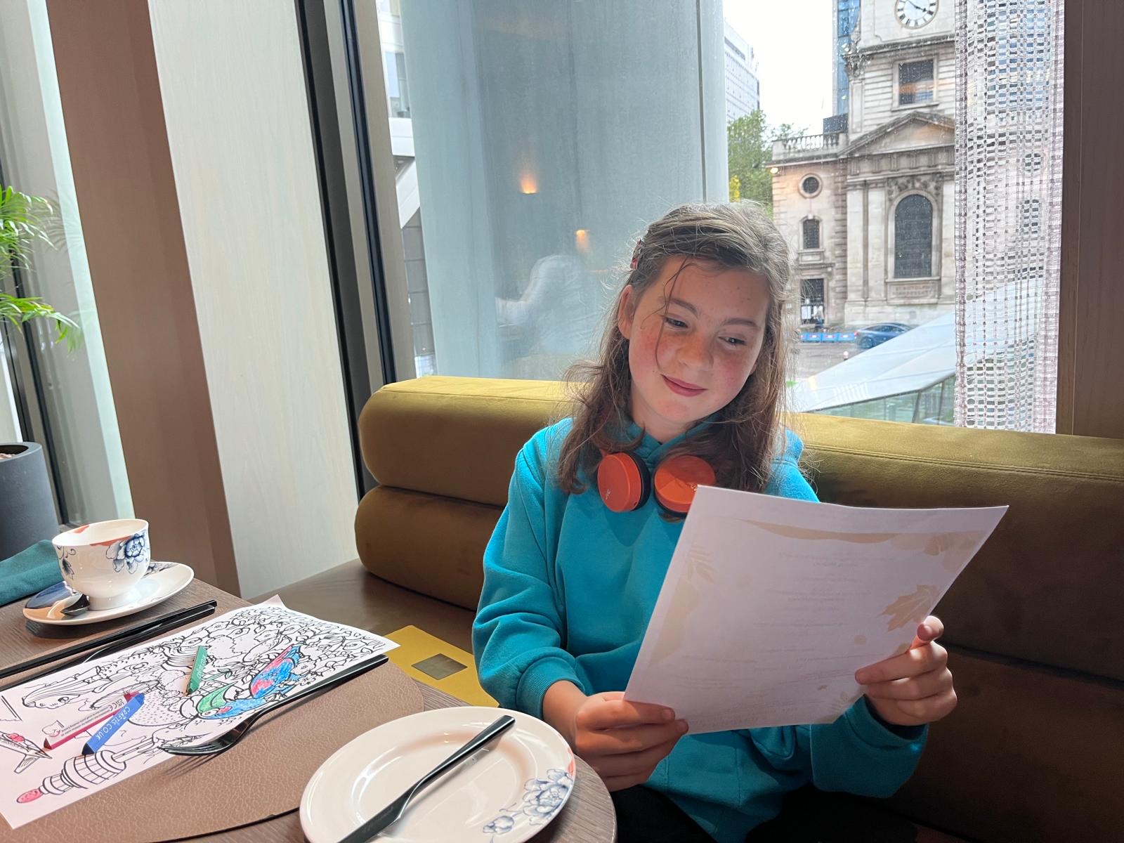 girl reading restaurant menu 