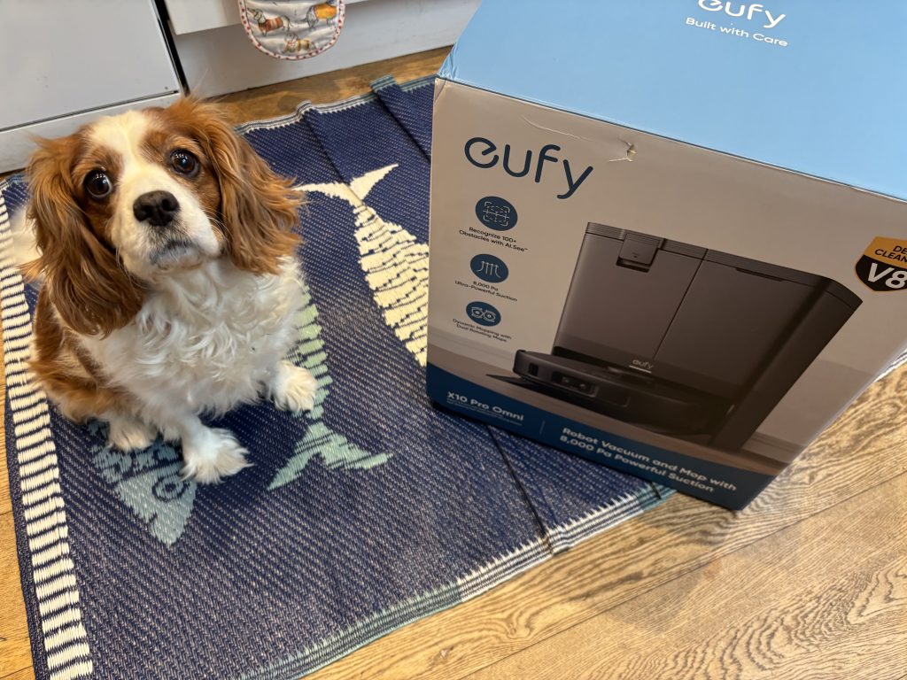 dog standing near eufy robot