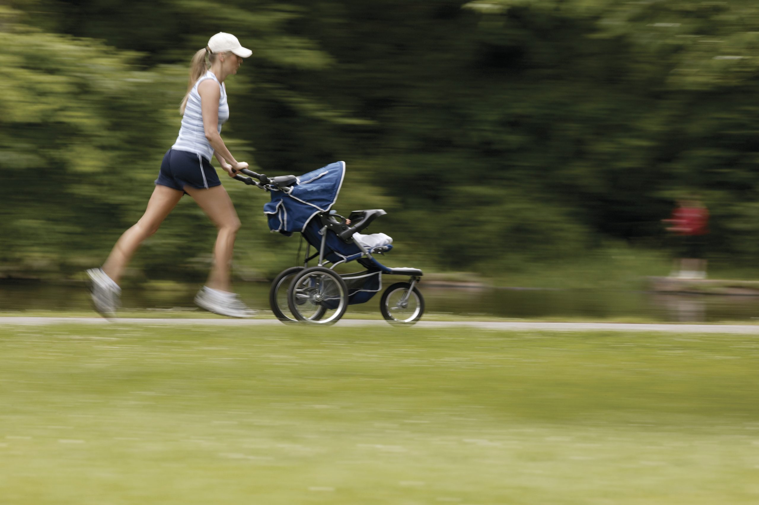 woman jogging with a baby stroller