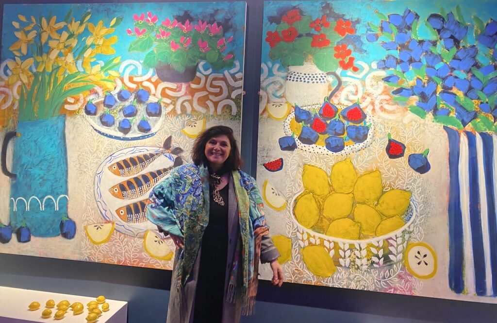 monica costa of london mums magazine at affordable art fair posing in front of Relton Marine paintings