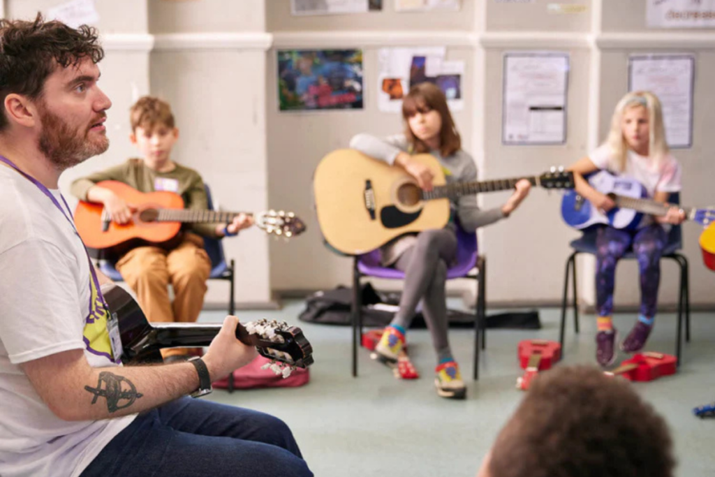 The strings club kids playing guitar