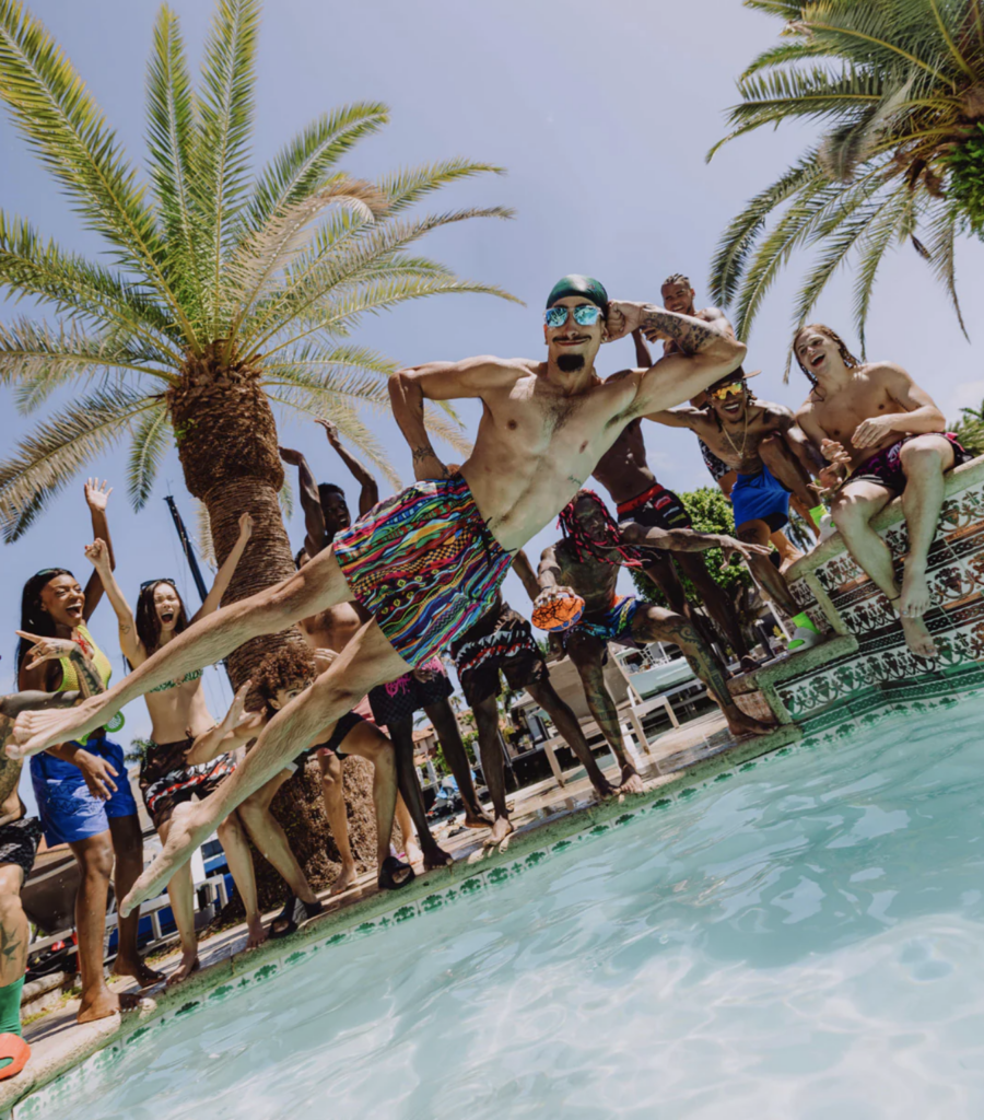 guy jumping in a swimming pool