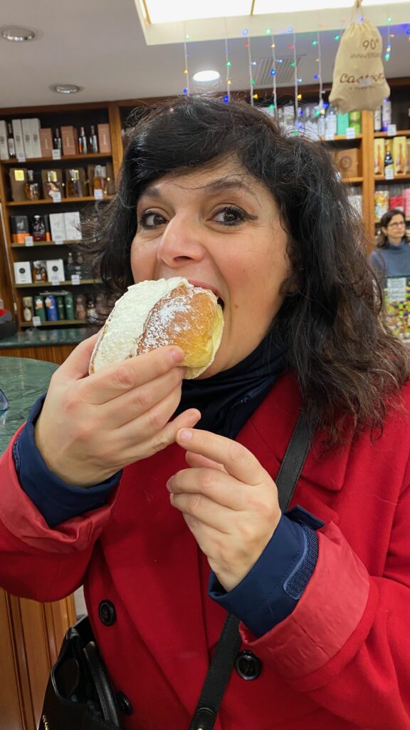 monica costa editor of london mums magazine eating a maritozzo in rome